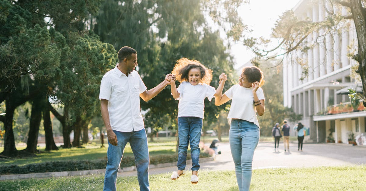Joyful family enjoying a playful day at the park, embracing love and togetherness under the summer sun.